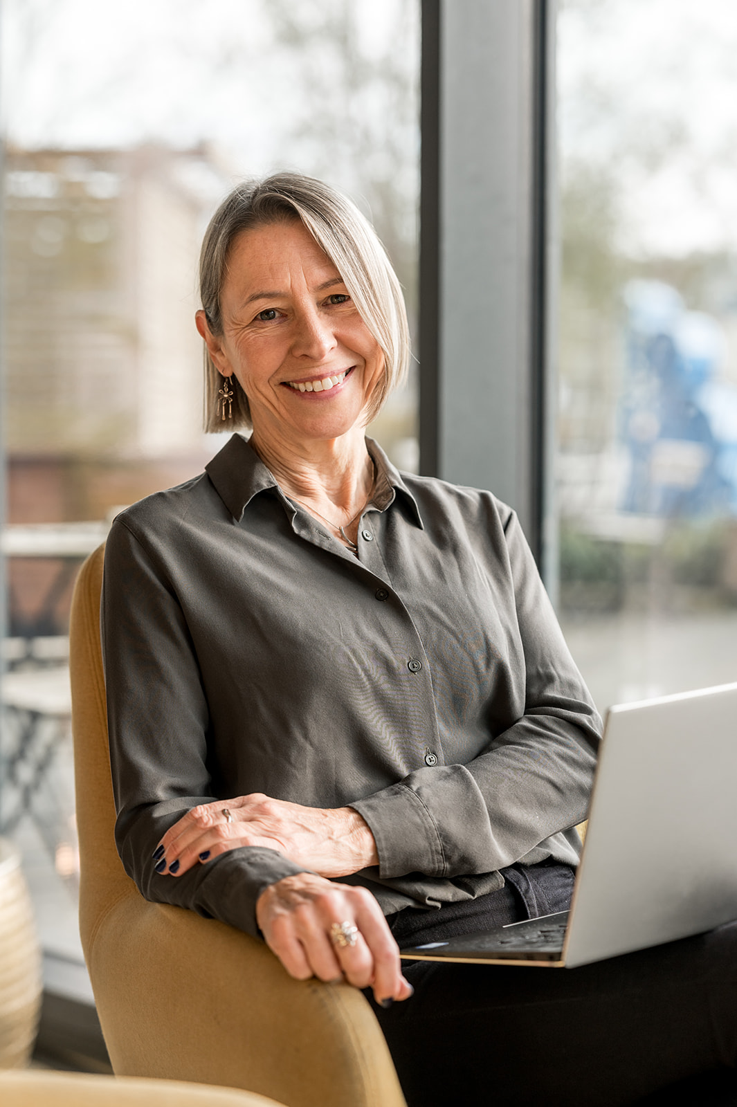 Karen Wills sitting, smiling